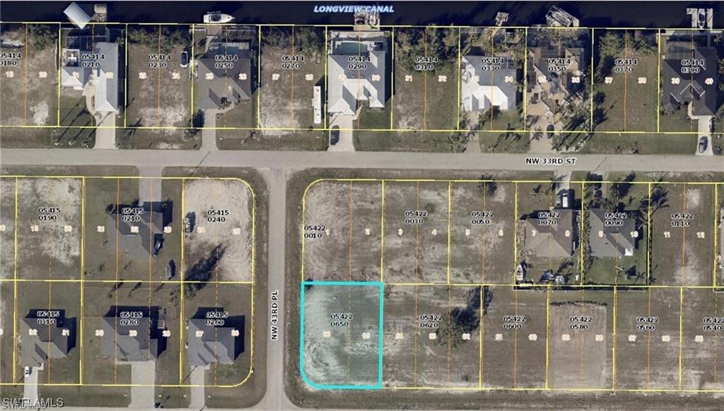 Expansive undeveloped lot with natural grass and clear skies