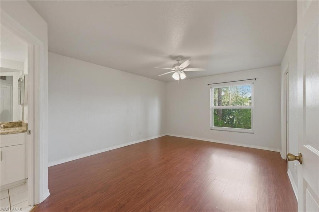 Primary Bedroom with  wood-style flooring