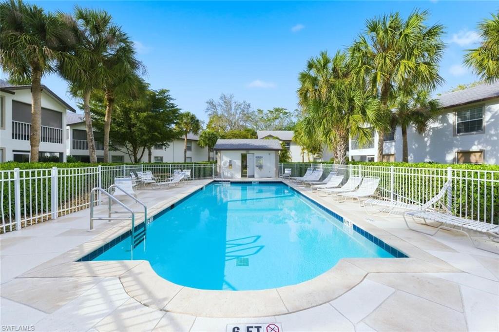Community pool featuring a patio area for lounging