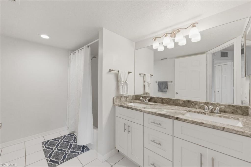 Primary Bathroom with double vanity and updated countertops & cabinets