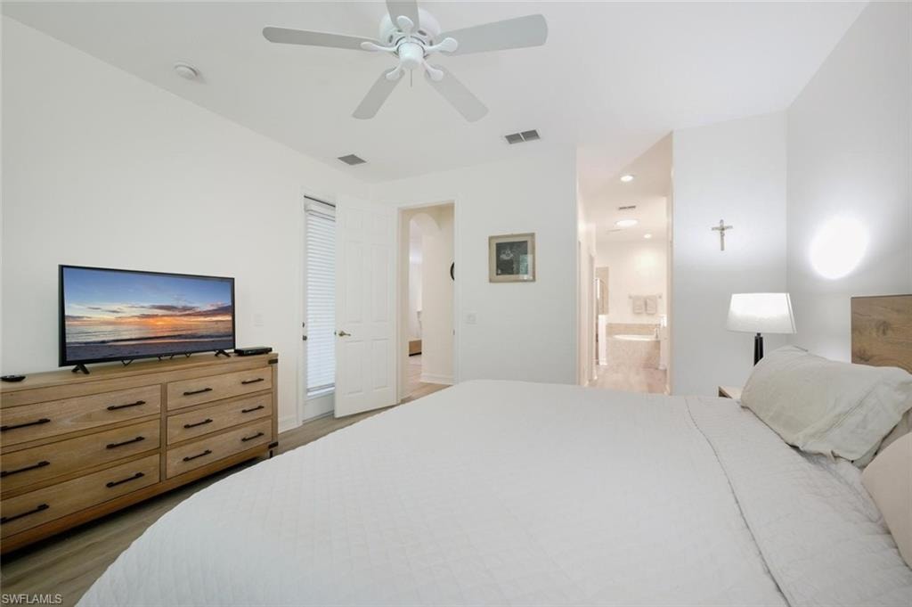 Wood-finish flooring, ceiling fan, and impact window with blinds