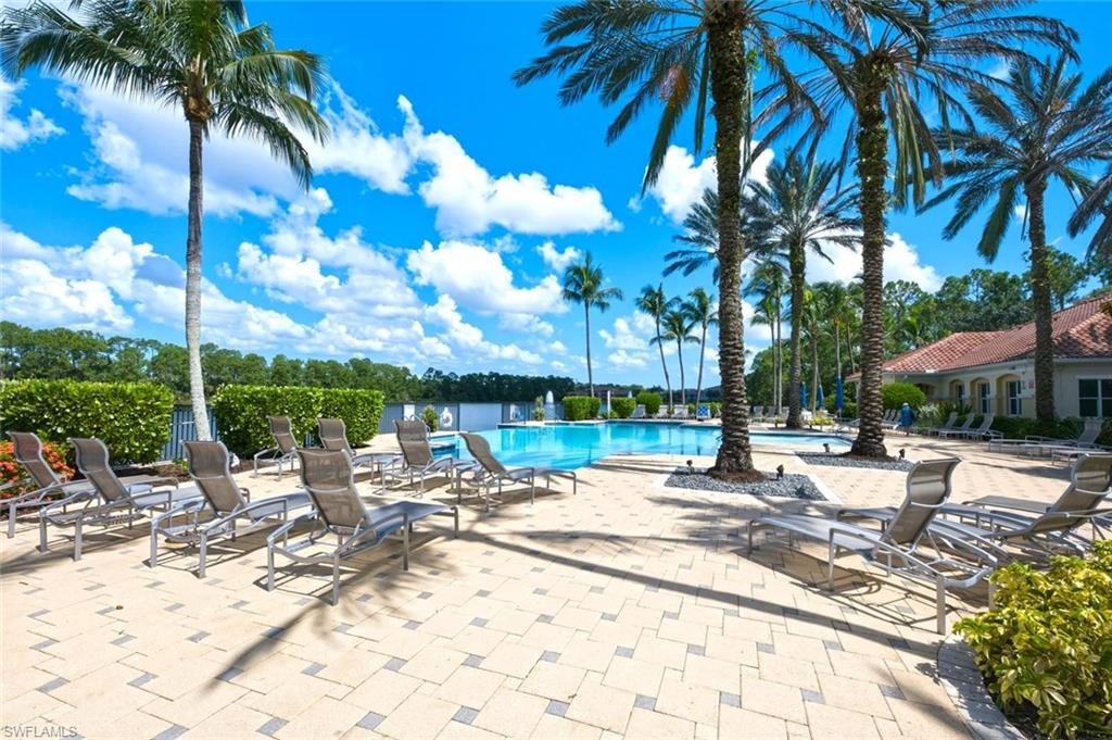 Expansive paver patio surrounding a pool with integrated water features