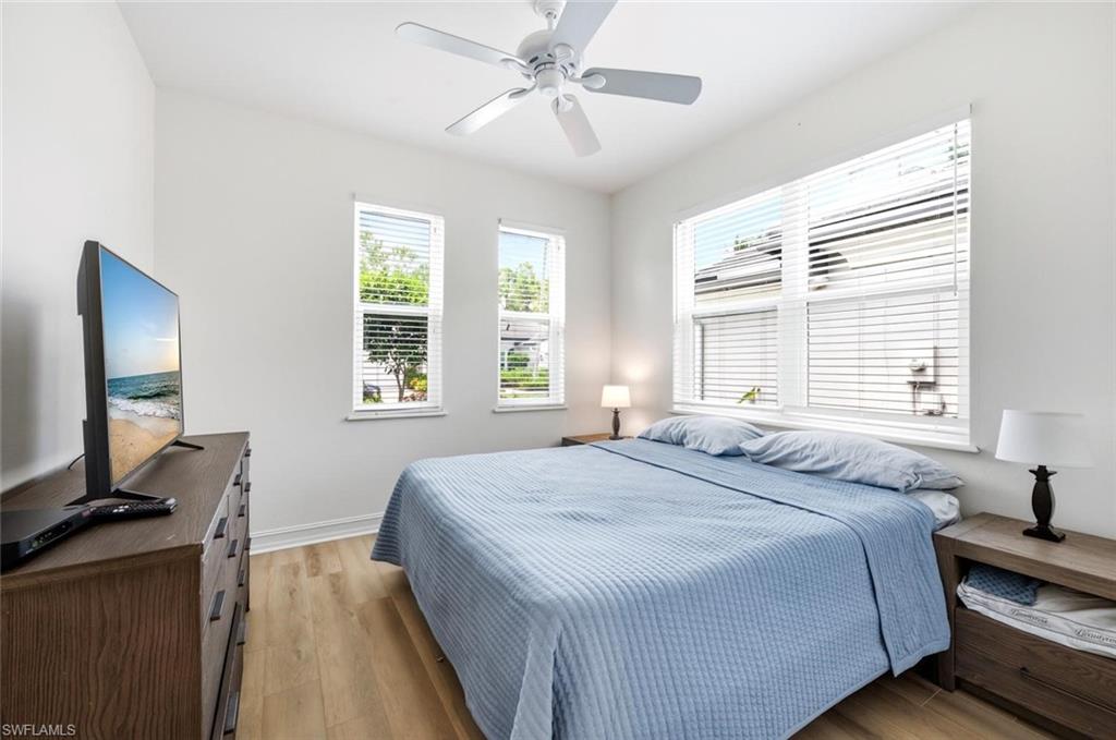 Smooth finish walls, wood-finish flooring, ceiling fan, multiple impact windows with blinds, and recessed lighting