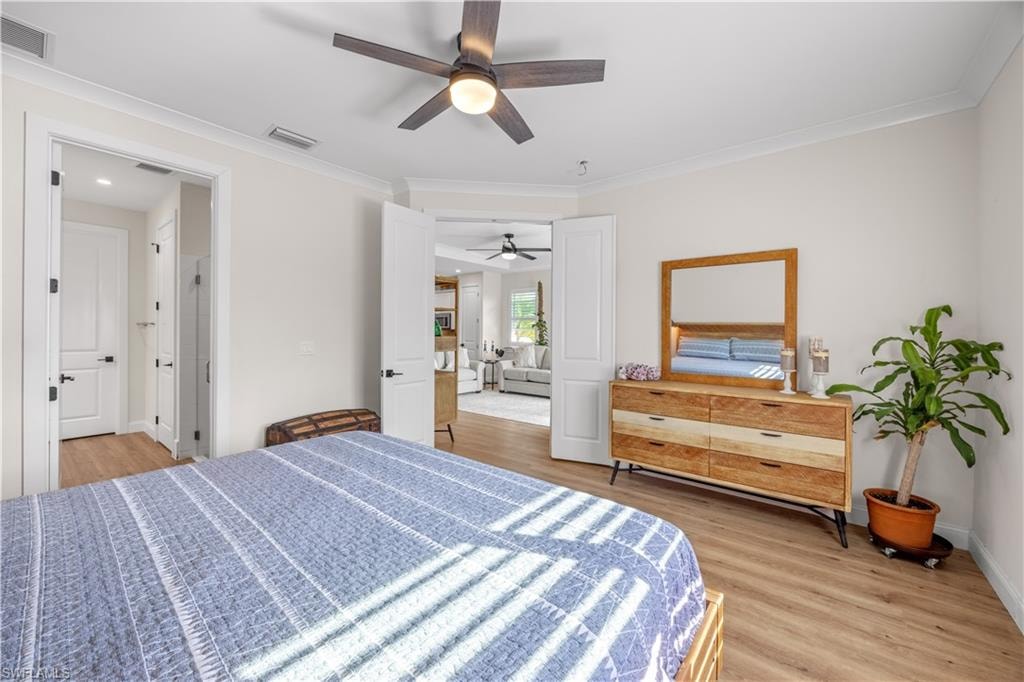 Wood-finish flooring, ceiling fan with integrated lighting, and white trim