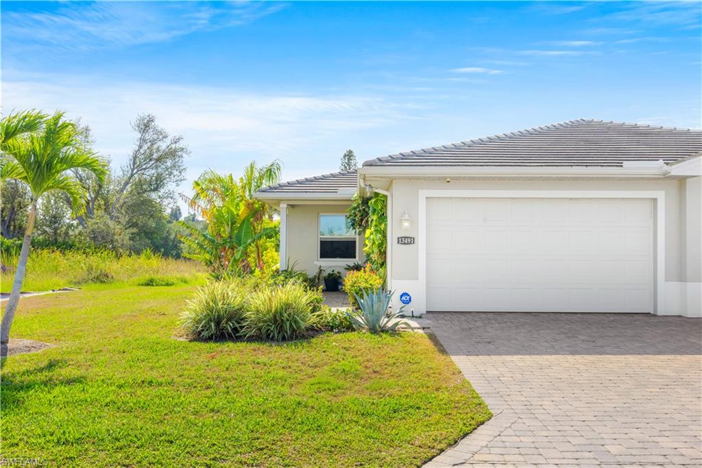 Stucco exterior with a tiled roof and an attached garage