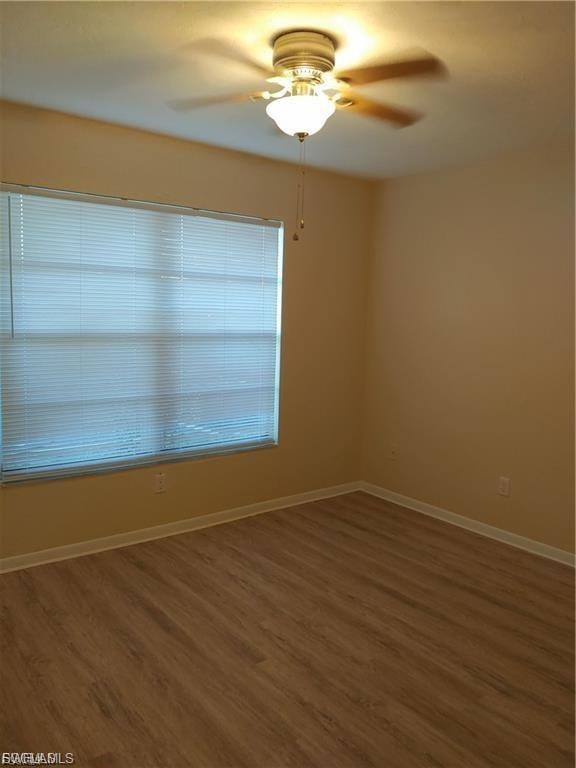 Wood-finish flooring, ceiling fan with integrated lighting, and window blinds