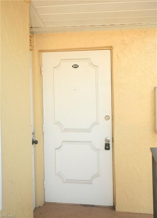 White paneled entry door with brass hardware