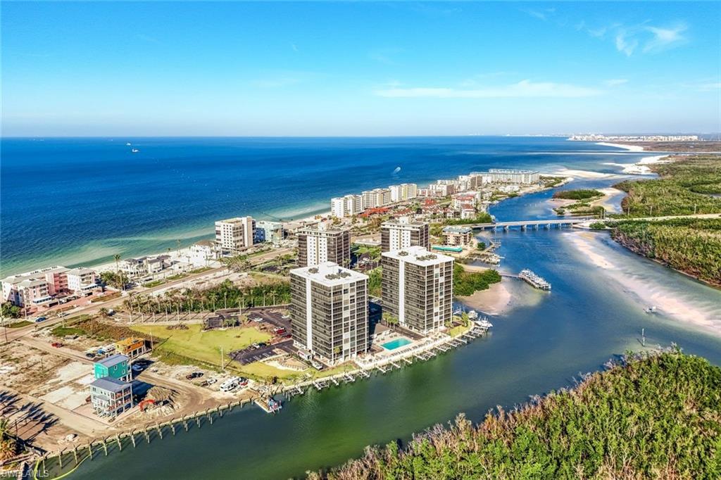 Aerial perspective showcasing coastal development with direct access to both ocean and river