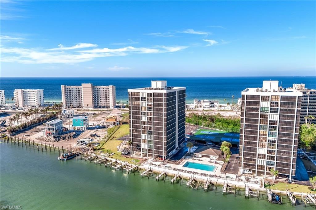 Waterfront high-rise community featuring a private swimming pool, tennis court, and direct water access with multiple boat slips