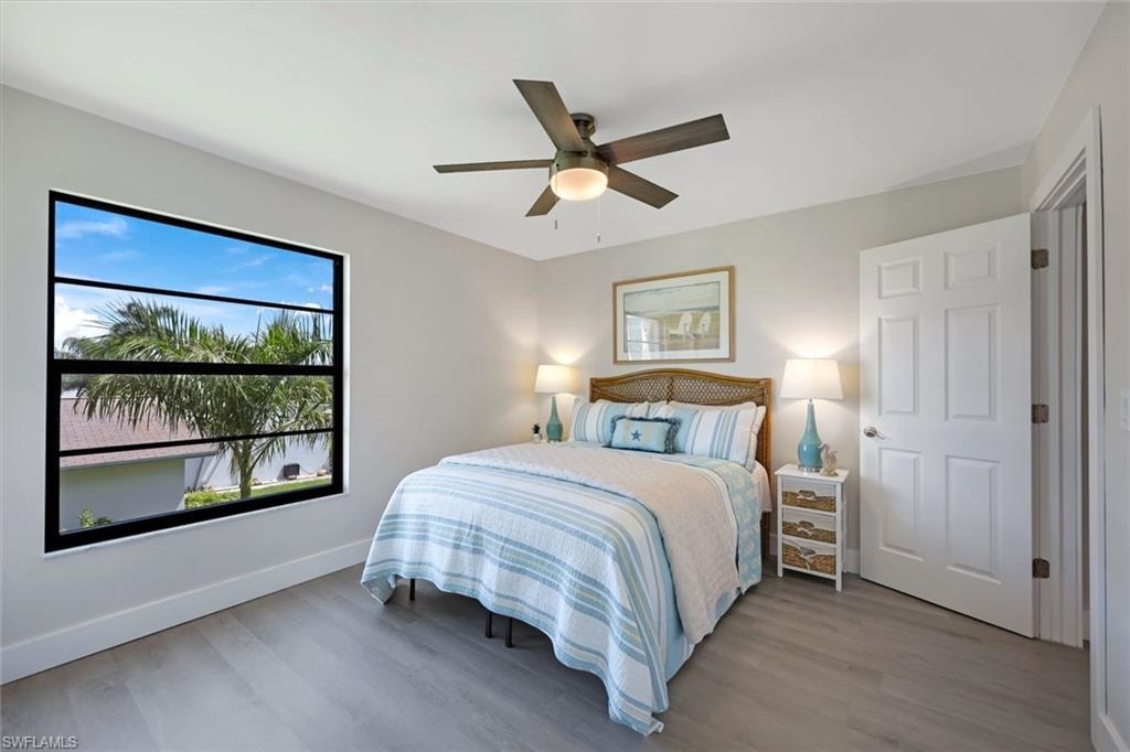 Guest bedroom with large window with view to the pool area