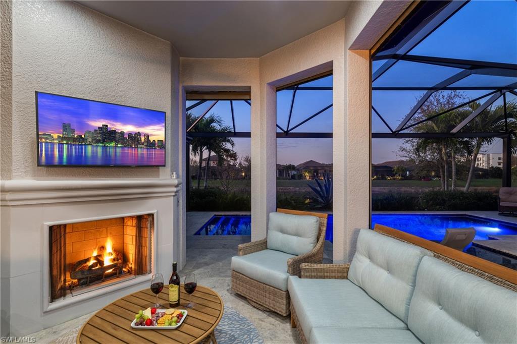 Outdoor fireplace with comfy seating and TV