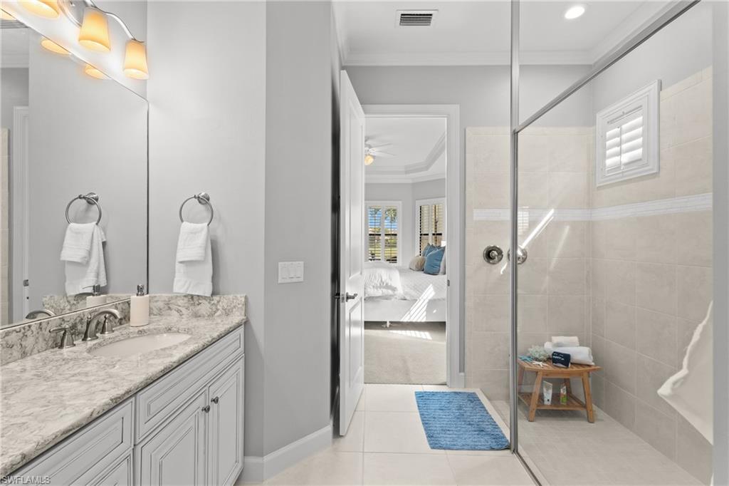 Vanity with a granite countertop, undermount sink, and brushed nickel faucet