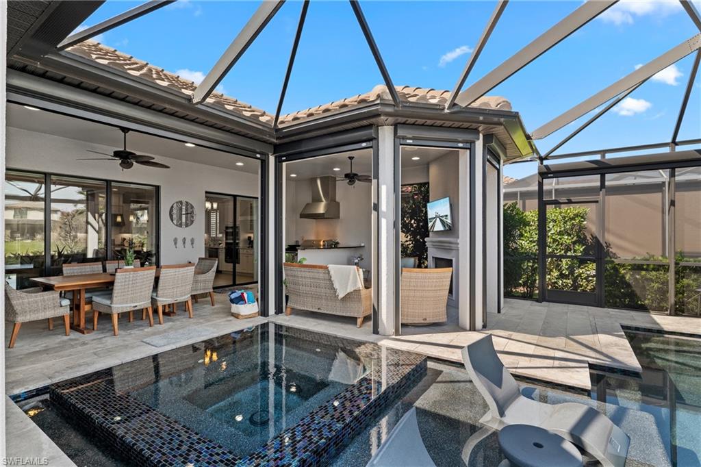 Full outdoor living complex with outdoor kitchen, dining, fireplace, spa and pool