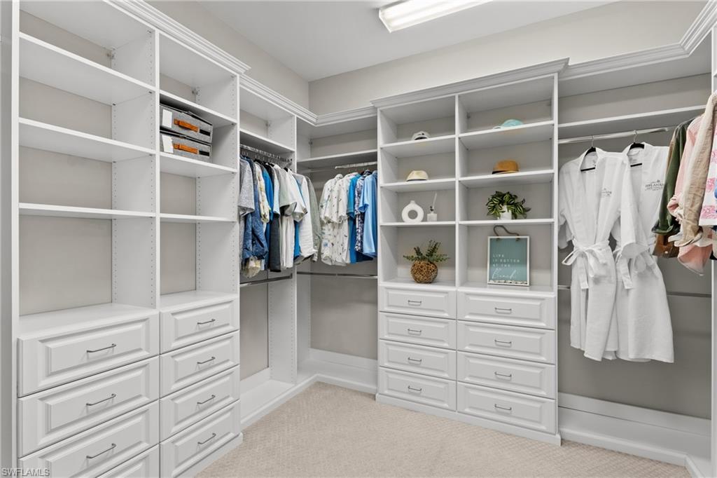 Custom closet system featuring extensive shelving, multiple built-in drawers, and dedicated hanging rods