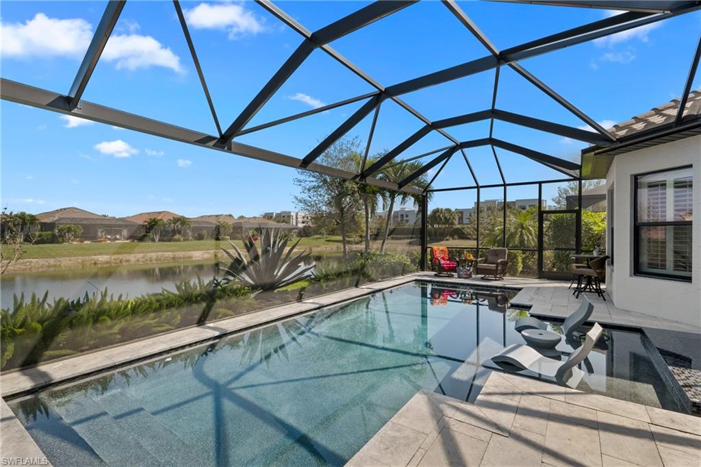 Screened lanai with a rectangular pool, tile patio, and integrated spa