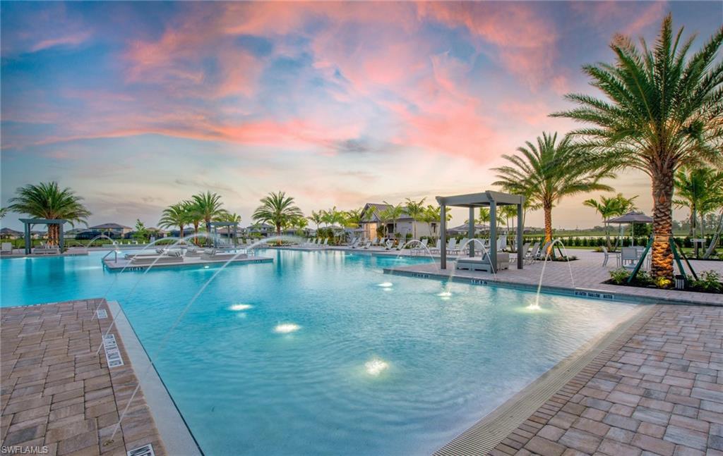 Expansive swimming pool featuring water jets and underwater lighting