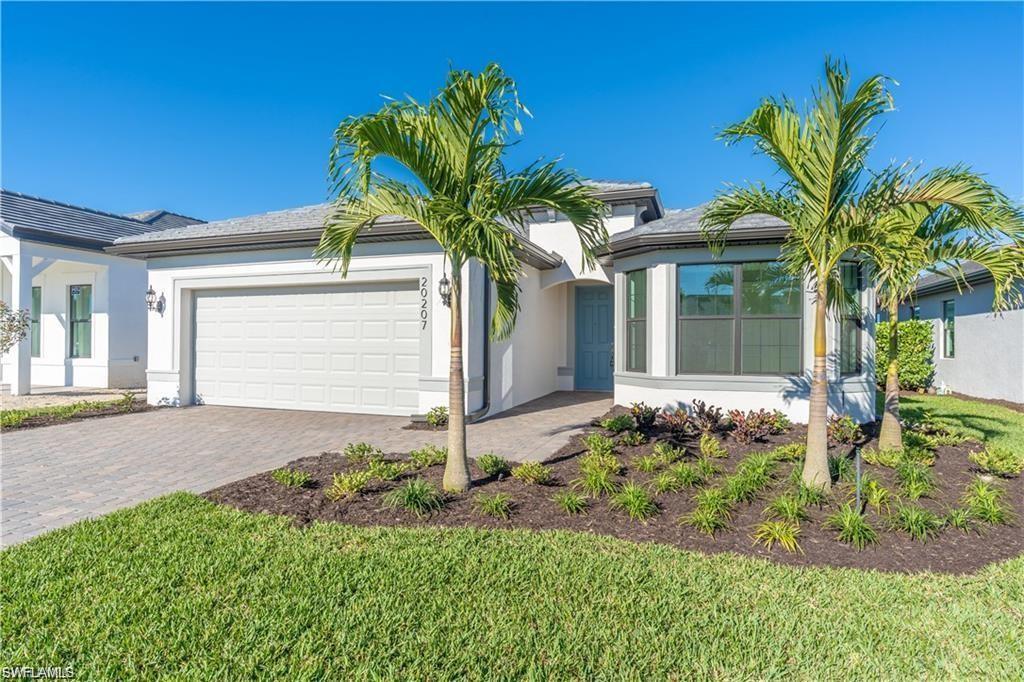 White stucco exterior with a gray tile roof