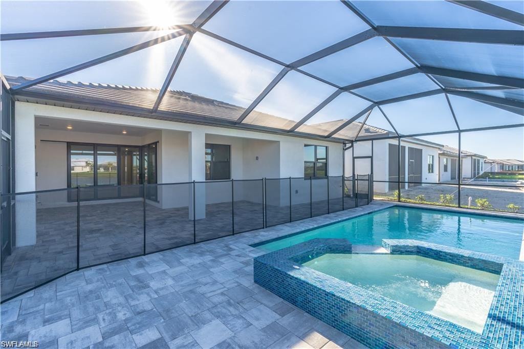 Screened-in lanai with a swimming pool and integrated spa