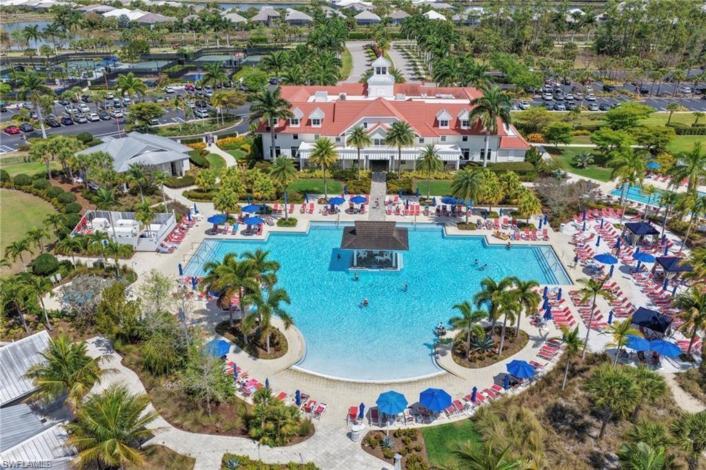 Expansive resort-style swimming pool featuring a central island structure and surrounding lounge areas