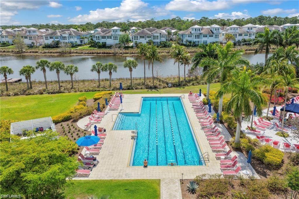 Expansive community pool with lap lanes and integrated sun shelf