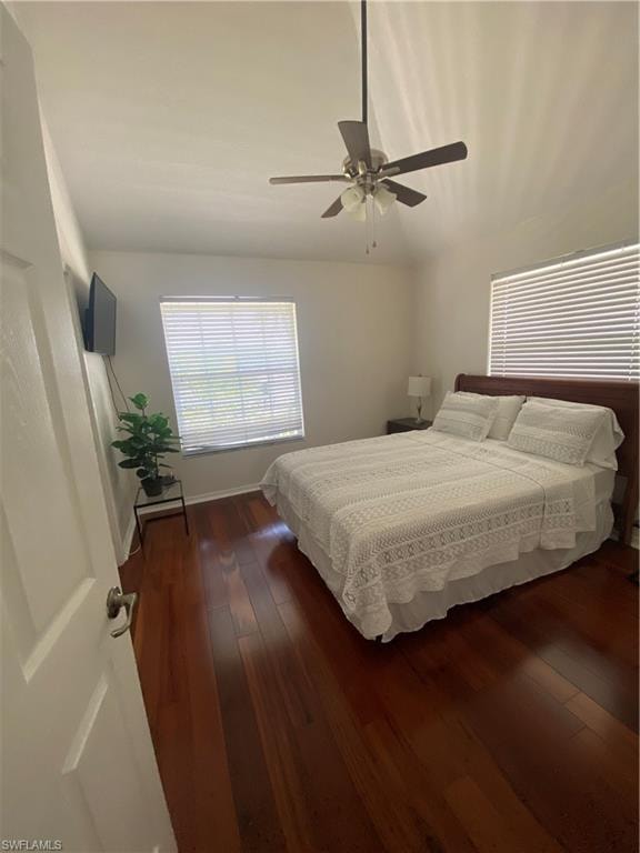Bedroom with dark wood-style flooring and ceiling fan