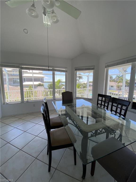 Dining room with lofted ceiling and light tile patterned floors