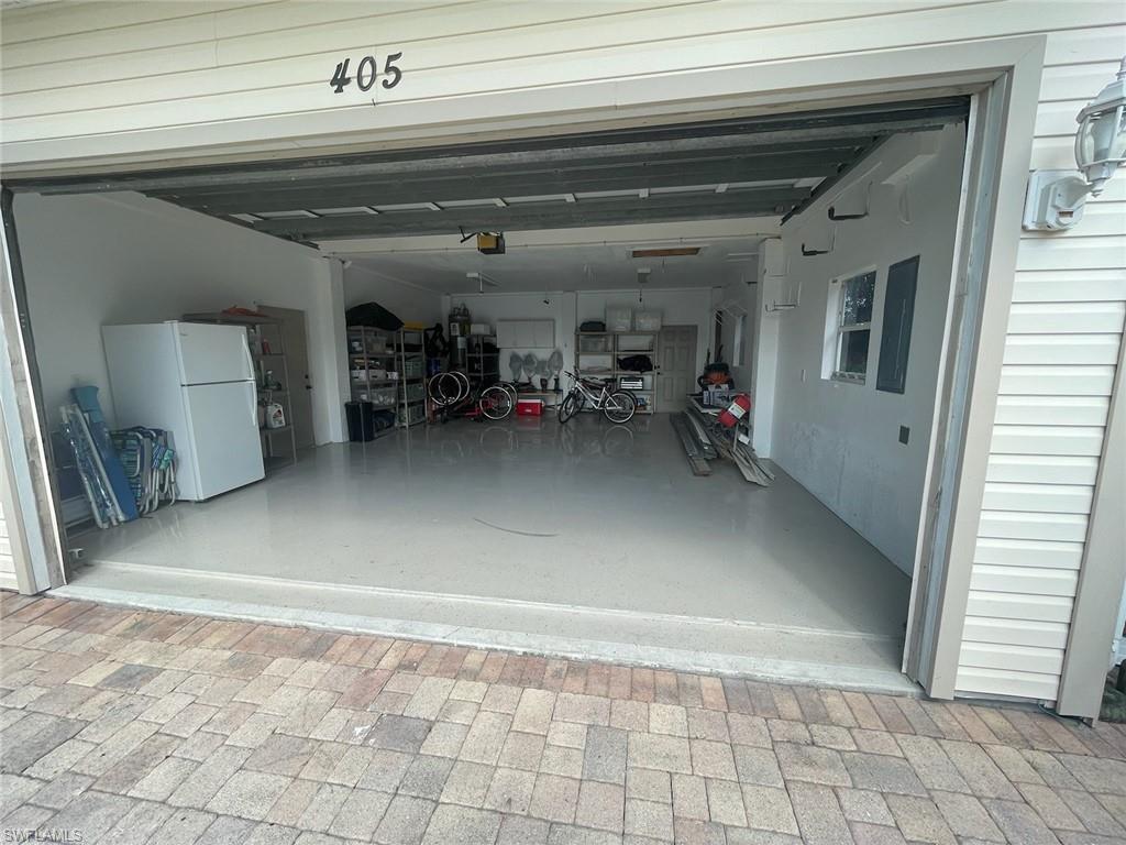 Garage featuring freestanding refrigerator