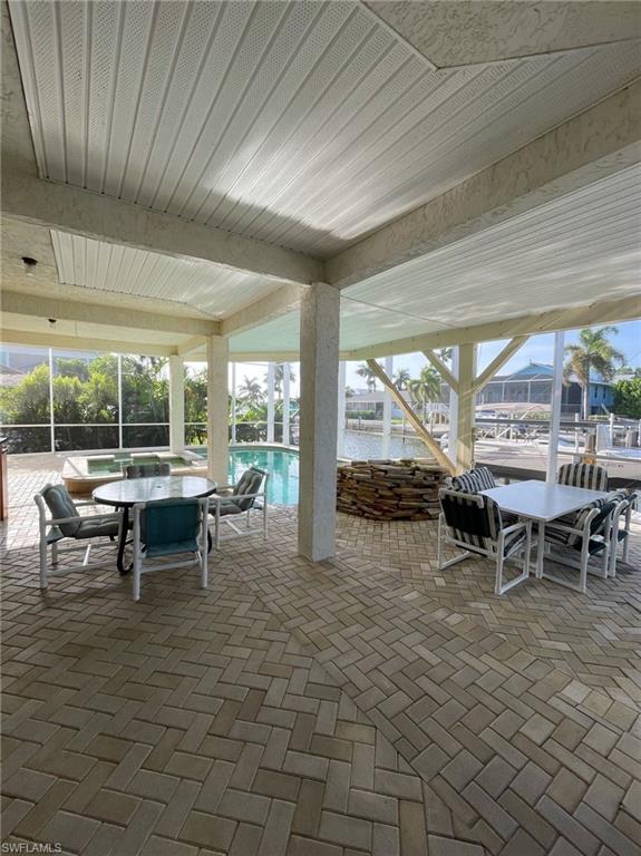 View of patio featuring outdoor dining space and an outdoor pool