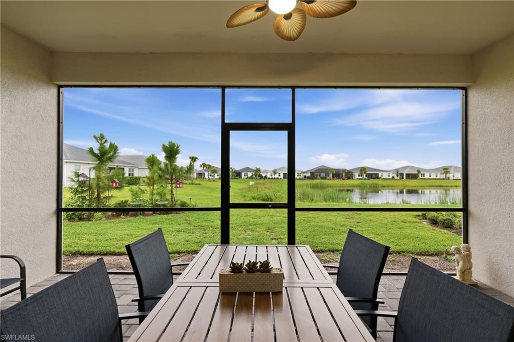 Screened lanai overlooking the backyard and lake, perfect for outdoor dining and relaxing