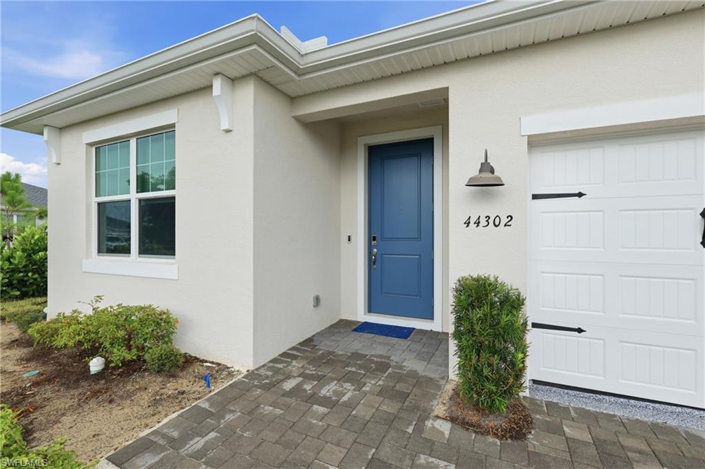 Welcome home! a covered front entry with a beautiful blue door creates a warm and inviting first impression