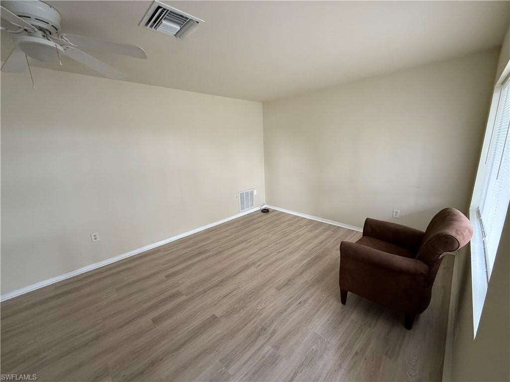 Sitting room featuring ceiling fan and light hardwood / wood-style flooring
