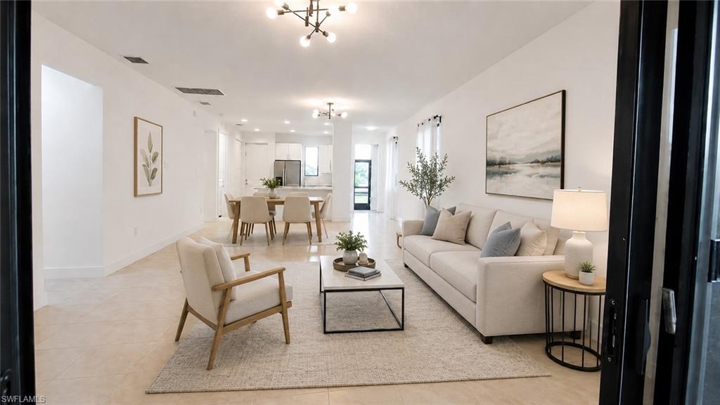 Open-concept living space featuring high ceilings, recessed lighting, and tile flooring