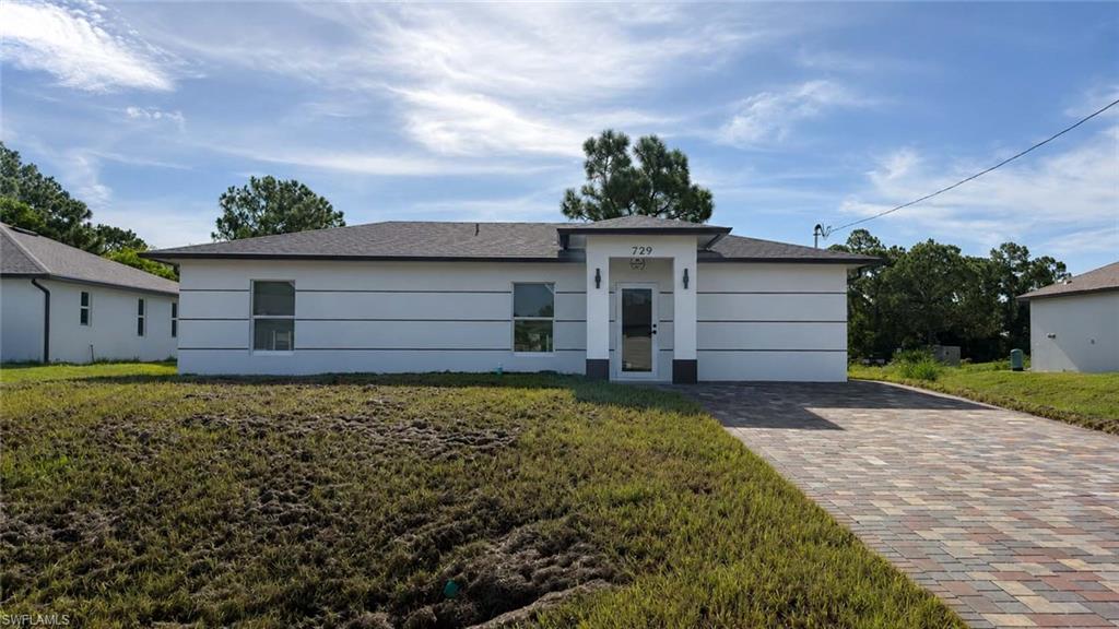 Contemporary exterior with a dark-shingled roof, a paved driveway, and horizontal accent banding