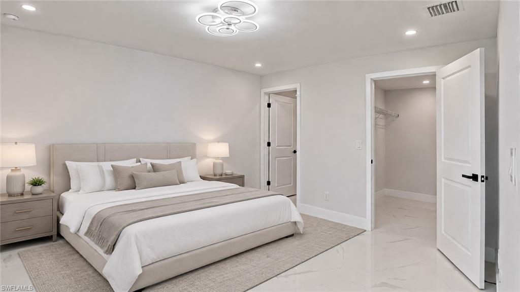 Recessed lighting, contemporary ceiling fixture, flat panel interior doors, and polished tile flooring