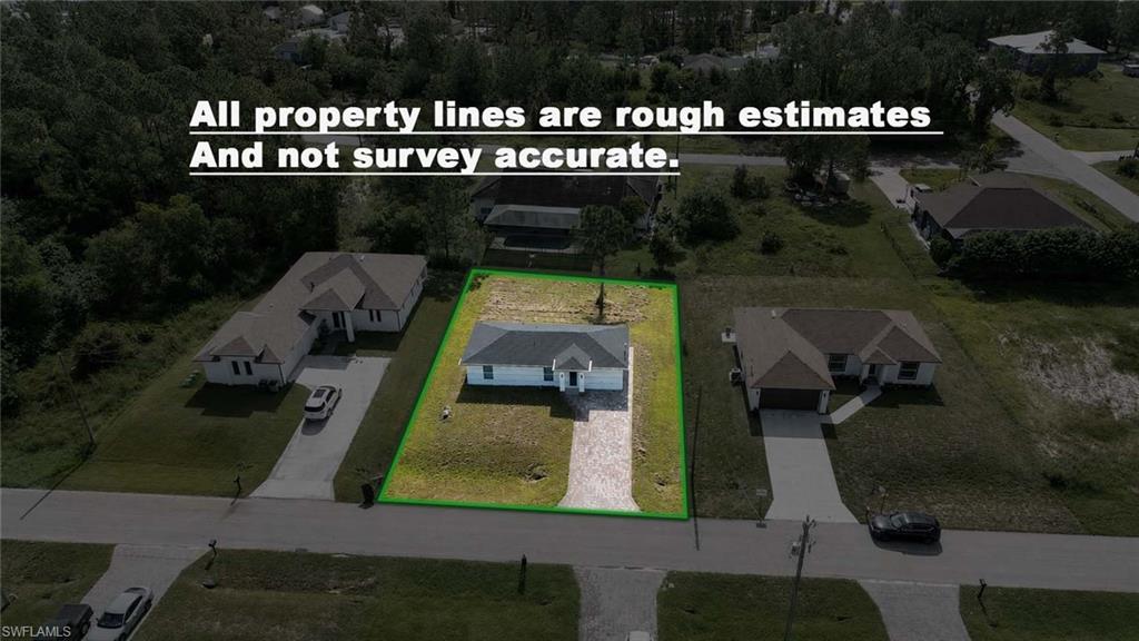 Single-story residence featuring a hip roof, attached garage, concrete driveway, and a partially landscaped yard
