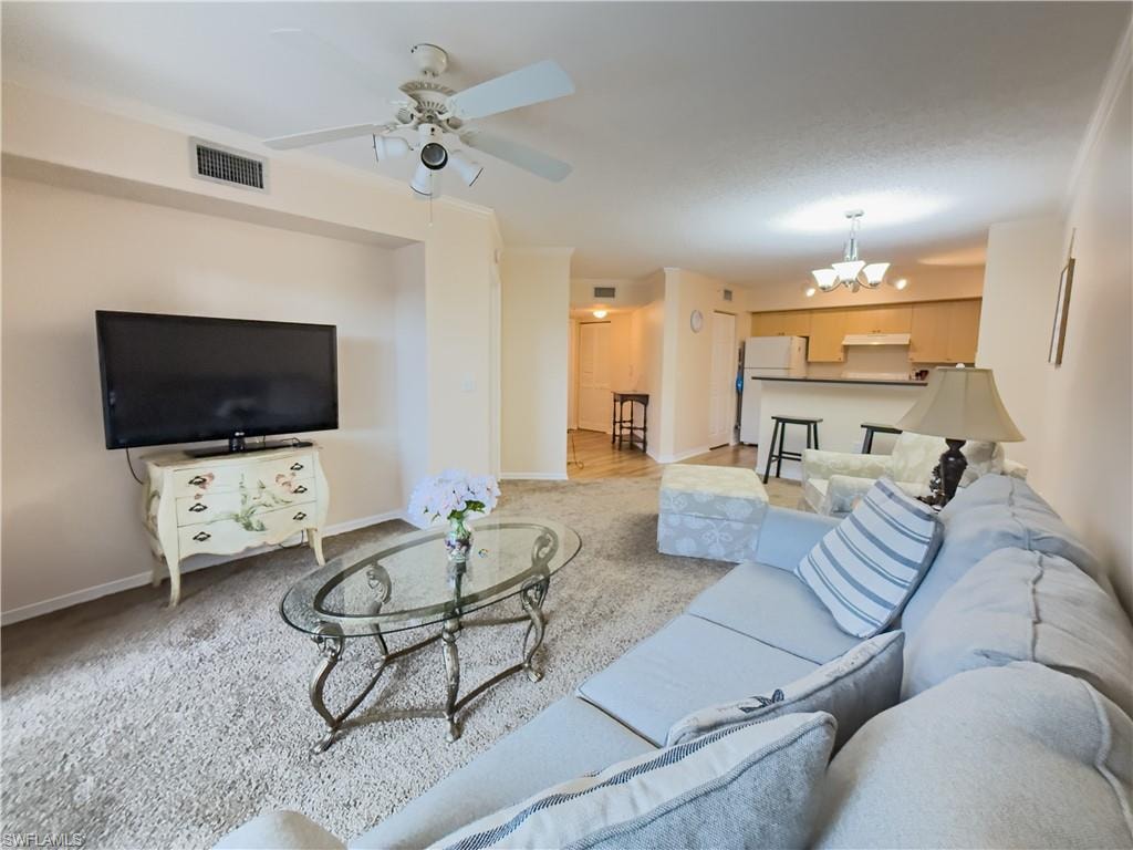 Living area featuring a chandelier and ceiling fan