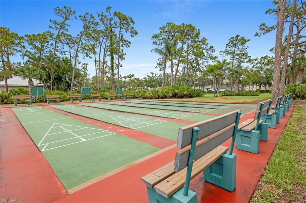 Multiple shuffleboard courts featuring green playing surfaces and white line markings