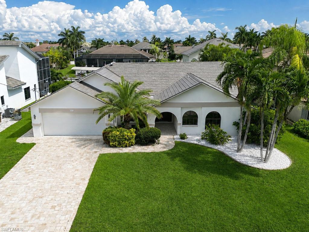 Virtually Enhanced Single-story residence featuring a tile roof, stucco exterior, and arched window details
