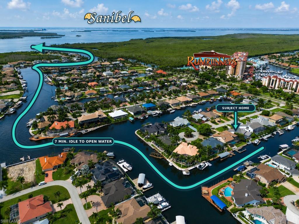 Aerial perspective showcasing a waterfront community with canal access, private boat docks, and proximity to open water