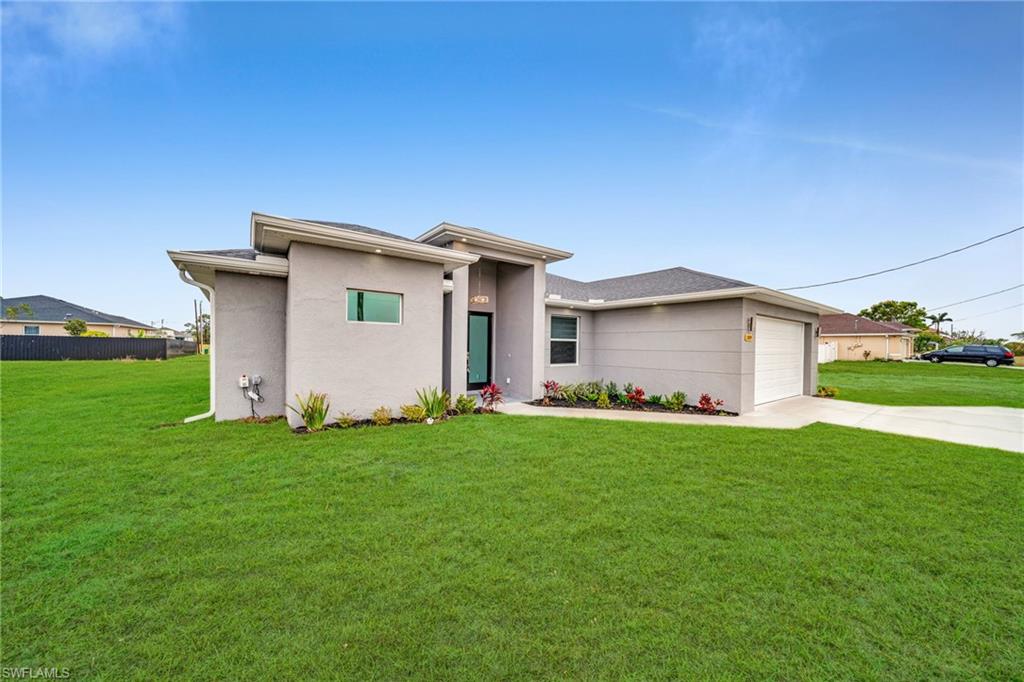 Contemporary exterior with a smooth stucco finish, a two-car garage, and a concrete driveway