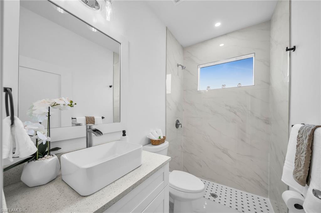 Modern vanity with a rectangular vessel sink, polished chrome faucet, and integrated quartz countertop