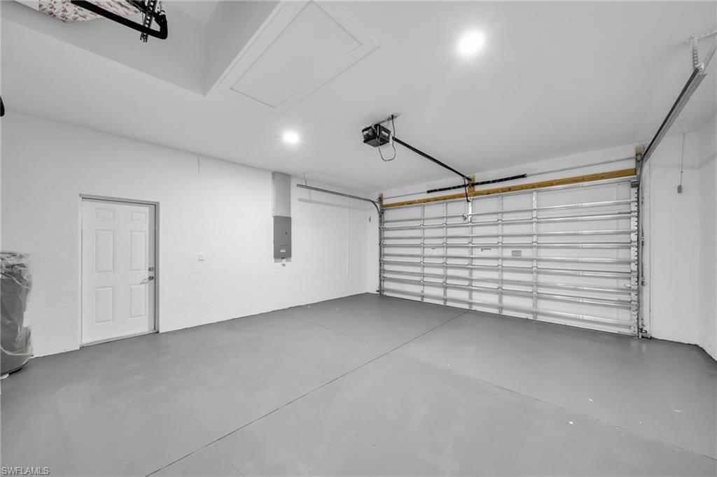 Spacious garage featuring a finished floor, recessed lighting, and an automatic garage door opener