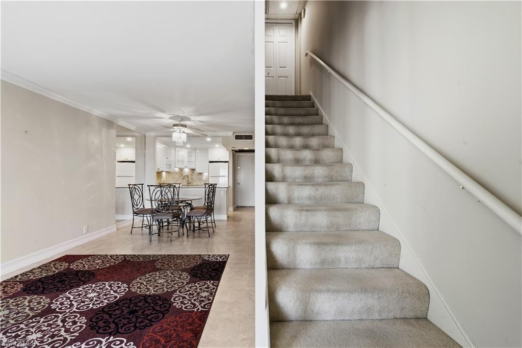 Carpeted staircase with a handrail