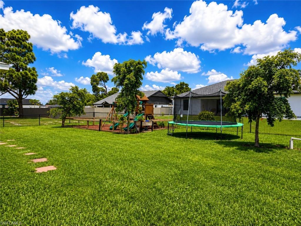 Expansive lawn with stepping stone pathway and mature trees