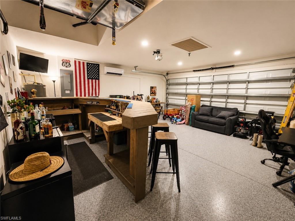 Epoxy-coated flooring, recessed ceiling lighting, wall-mounted mini-split system, and garage door access