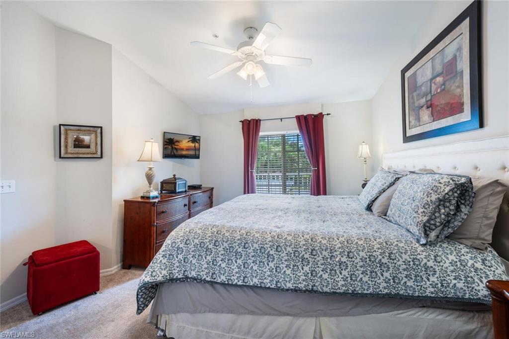 Bedroom featuring carpet flooring, a ceiling fan, and vaulted ceiling