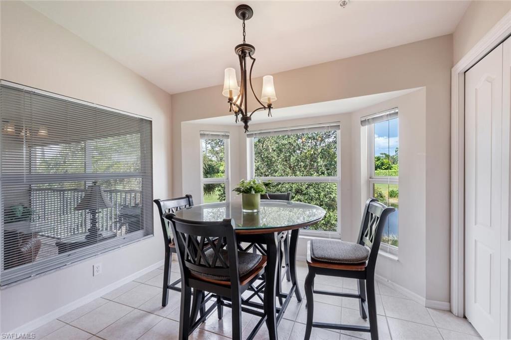 Dining room featuring light tile patterned flooring and a chandelier