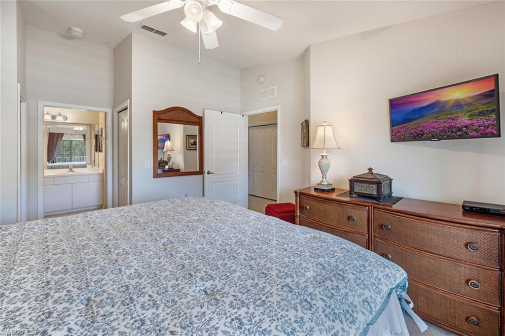 Bedroom with a closet, ceiling fan, and ensuite bathroom