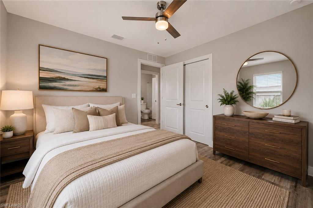 Comfortable guest bedroom with a spacious closet, luxury vinyl plank flooring, and easy access to the nearby full bathroom. [Virtually Staged]