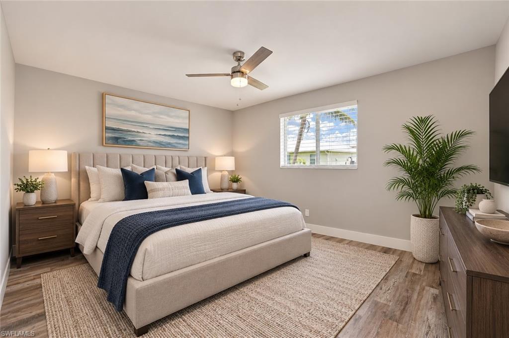 Spacious primary suite featuring a tray ceiling, luxury vinyl plank flooring, generous natural light, and ample space for a king-size bedroom set. [Virtually Staged]